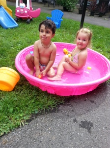 Playing with his girlfriend in the kiddie pool